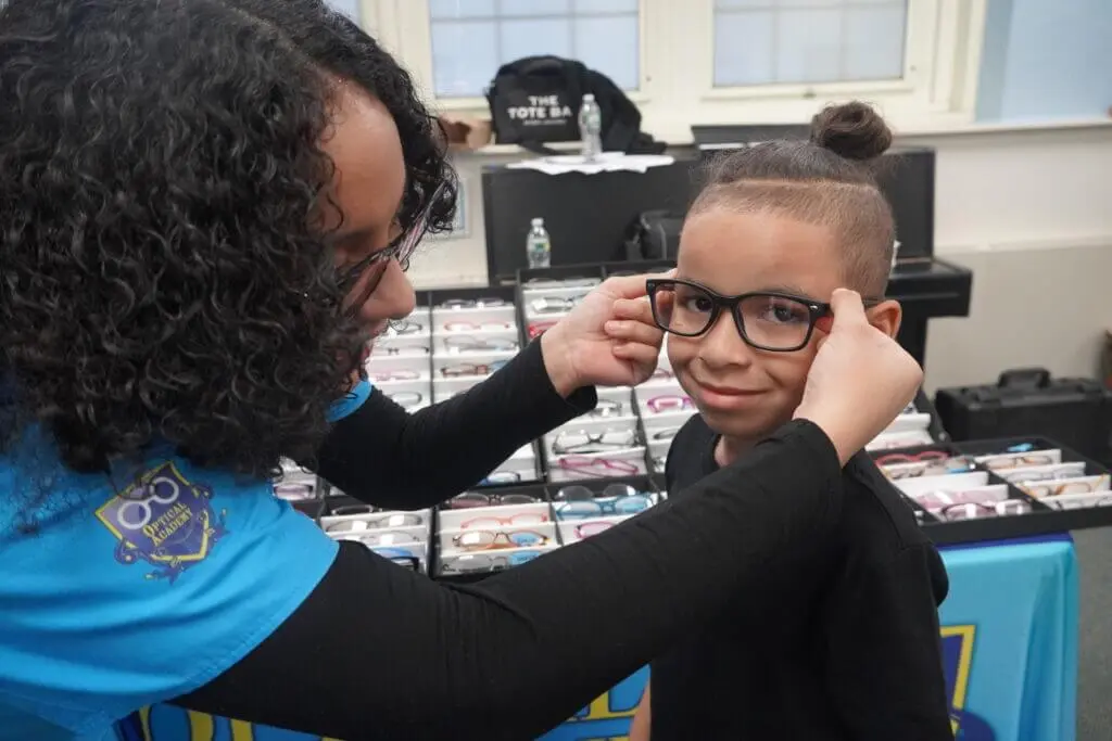 Student choosing from prescription eyewear frames